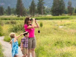 mom, son, and daughter watching wildlife at Lee Metcalf NWR